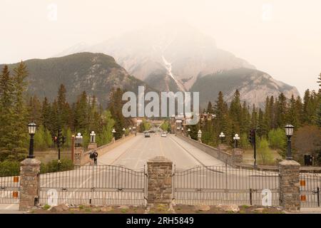 View looking down smokey Banff Avenue during wildfires. Cascade Mountain obscured by smoke haze. Stock Photo