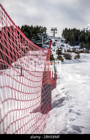 A Detail of orange plastic barrier on ski slope Stock Photo