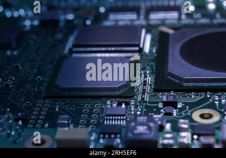 Intricate circuit board with computer hardware, showcasing complexity of electronics industry. Stock Photo