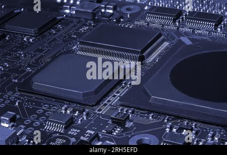 Intricate circuit board with computer hardware, showcasing complexity of electronics industry. Stock Photo