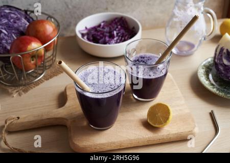 Purple cabbage juice in two glass cups with ecological bamboo drinking straws Stock Photo