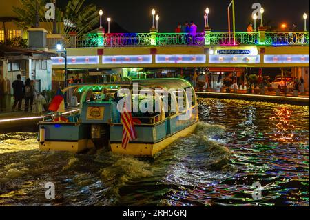 Malacca River Cruise boat sailing down the Malacca river at night Stock Photo