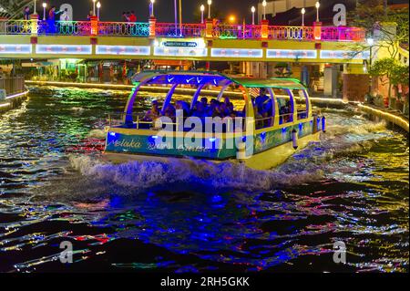 Malacca River Cruise boat sailing down the Malacca river at night Stock Photo