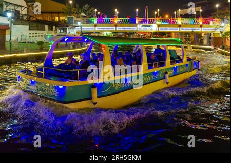 Malacca River Cruise boat sailing down the Malacca river at night Stock Photo