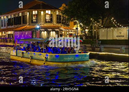 Malacca River Cruise boat sailing down the Malacca river at night Stock Photo