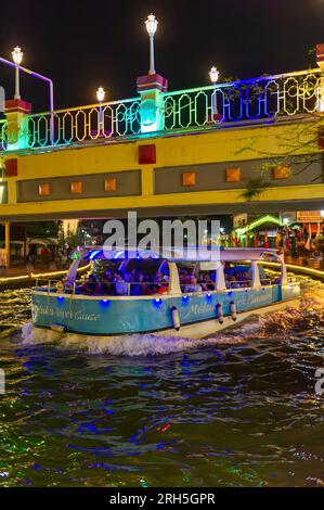 Malacca River Cruise boat sailing down the Malacca river at night Stock Photo