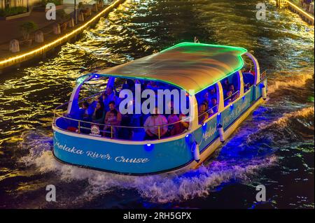 Malacca River Cruise boat sailing down the Malacca river at night Stock Photo