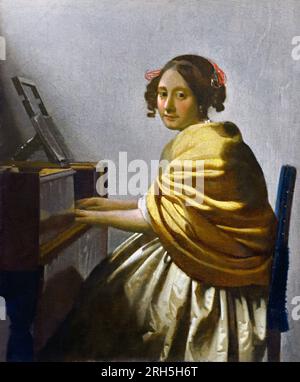 Young woman painter in golden frame with color palette and paint brush ...