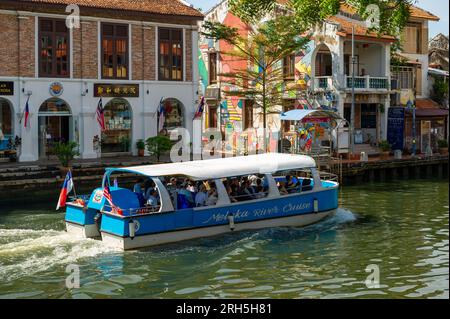 Malacca River Cruise boat sailing down the river on a sunny day Stock Photo