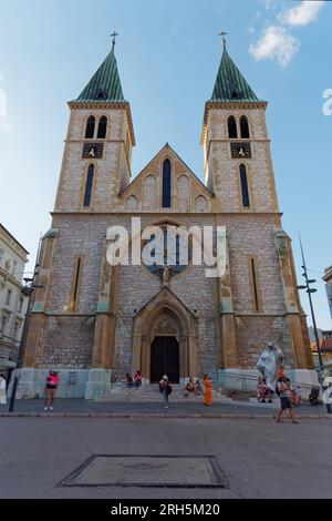 Sacred Heart Catholic Cathedral with Sarajevo Rose Bosnian War memorial in front. Sarajevo, Bosnia and Herzegovina, August 13, 2023. Stock Photo