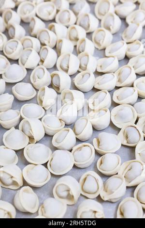 Rows of beautiful dumplings on a grey tabletop, close-up Stock Photo