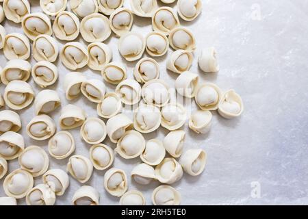 Rows of beautiful dumplings on a grey table, top view Stock Photo