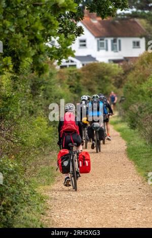 large group of cyclists on a bike ride together along a country lane on the isle of wight Stock Photo