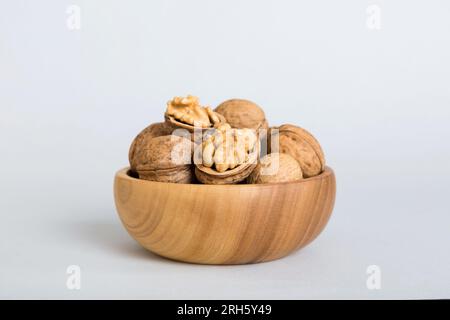 Fresh healthy walnuts in bowl on colored table background. Top view Healthy eating bertholletia concept. Super foods. Stock Photo
