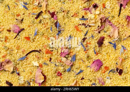 Couscous with dried flowers full frame as background close up Stock Photo