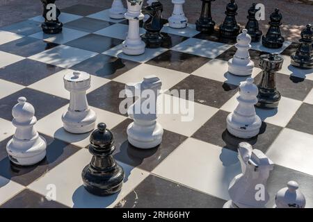 Chess Giant chess board game set in the garden. Stock Photo