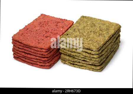 Heap of vegetable crackers seasoned with spinach isolated on white ...