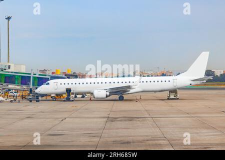 A passenger plane is being prepared at the airport terminal for the boarding of passengers Stock Photo