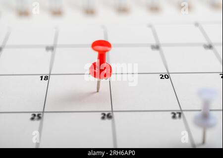 Pushpins on calendar. Business management event, business plan targeted marketing activities. Embroidered pins on calendar event. Planner calendar, pl Stock Photo