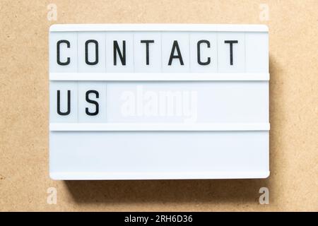 Lightbox with word contact us on wood background Stock Photo