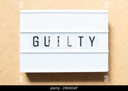 Lightbox with word guilty on wood background Stock Photo