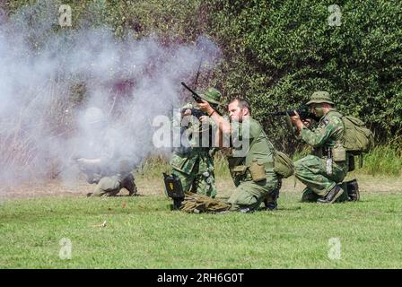 1st Cavalry Division of the United States Army battle re-enactment. Enthusiasts in military war scenario wearing army uniforms & equipment Stock Photo