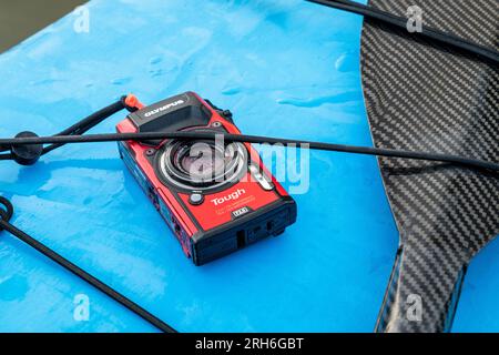Fort Collins, CO, USA - June 6, 2023: Compact, waterproof Olympus Stylus Tough TG-5 camera on a wet deck of a stand up paddleboard.