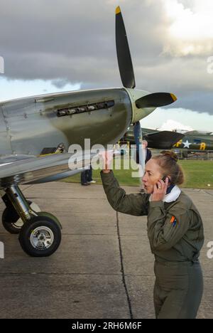 Carolyn Grace, female pilot and owner of Supermarine Spitfire Second World War fighter plane. Pushing World War Two Spitfire TIX ML407 back to hangar Stock Photo