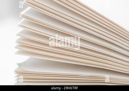 Bending stack of paper sheets, open magazine with copy space Stock Photo