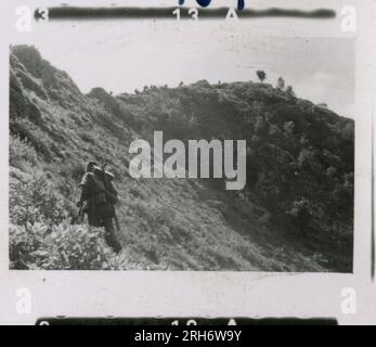 SS Photographer, Heiss (1943) Unit and soldiers in barracks, visit by Himmler with formal ceremony including Hitler Youth, unit movement by rail, soldiers manning an observation post in mountains, patrol in mountainous terrain and field activities, machine gun crew. Stock Photo