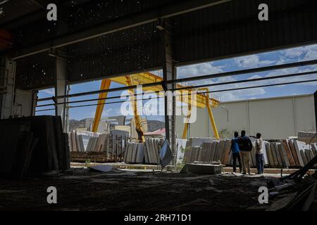 Abiy Adi, Ethiopia. 17th May, 2023. A group of men look at bullet holes at a factory near Wikro. Northern Ethiopia is still suffering from the effects of the 2020 war, now on pause. More than 800,000 women and children need help, but major humanitarian organisations have stopped food shipments because of suspicions of theft. (Photo by Edgar GutiÈrrez/SOPA Images/Sipa USA) Credit: Sipa USA/Alamy Live News Stock Photo