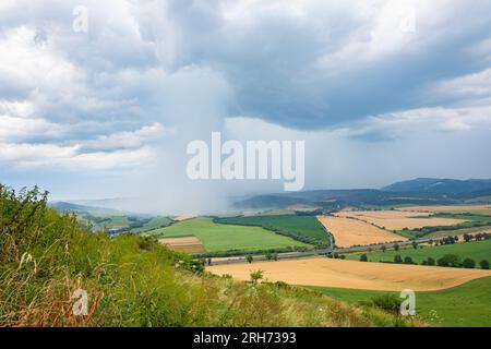 Distinct rain shaft from a thunderstorm over the hilly countryside of northern Slovakia Stock Photo