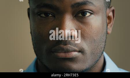 Angry serious man face close up headshot african american 30s businessman worker employee salesman adult ethnic male portrait indoors looking at Stock Photo