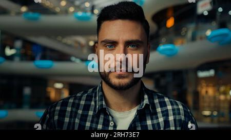 Close-up single male portrait of Caucasian bearded guy confident businessman young 30s man customer client shopper in trendy casual shirt posing Stock Photo