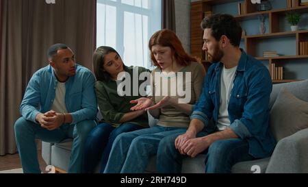 Upset woman cry desperate bullying at home multiethnic team friends support sad anxious girl on group psychological therapy colleagues women and men Stock Photo