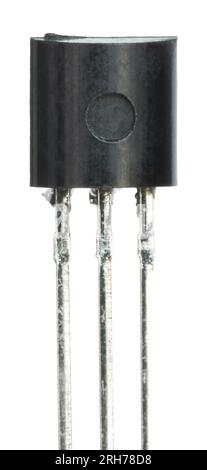 Small black transistor with silver colored wires for connecting into integrated circuits Stock Photo