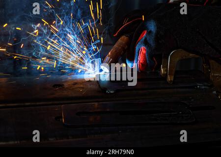 Using semi automatic argon arc welding welder executes professional welding tasks Stock Photo