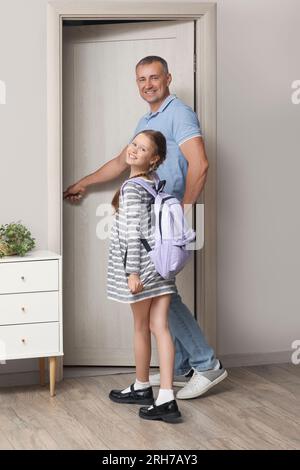 Father walking his little daughter to school in hall Stock Photo