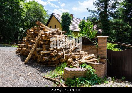 Pile of logs for winter in front of house near forest, Sopron, Hungary Stock Photo