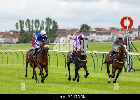 Race horses running along the flat turf track at Ayr Racecourse, Ayr, Scotland Stock Photo