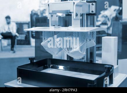 Printed models on 3D printer close-up. Objects printed on photopolymer sla 3D printer from liquid photopolymer resins on printing platform. Modern progressive additive technology. 3D printer printing Stock Photo