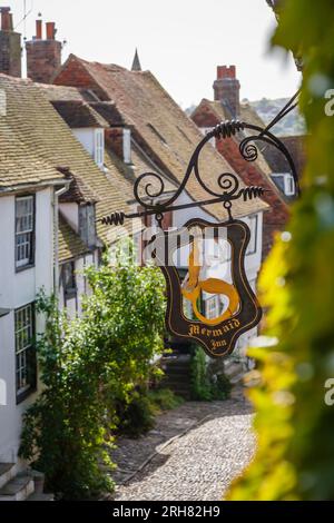 The name sign outside the ancient Mermaid Inn, a listed building, pub, hotel and restaurant in cobbled Mermaid Street, Rye, East Sussex, UK Stock Photo