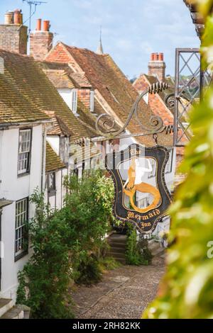The name sign outside the ancient Mermaid Inn, a listed building, pub, hotel and restaurant in cobbled Mermaid Street, Rye, East Sussex, UK Stock Photo