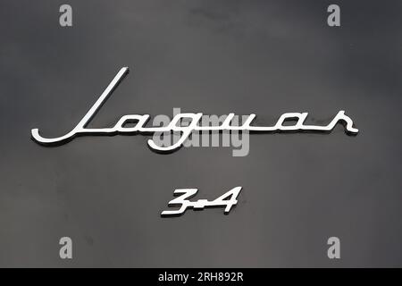 Chrome script badge on the boot lid of a 1957 Jaguar 3.4 litre Mk I sports saloon, a fearsome beast, but successful in competition, August 2023. Stock Photo