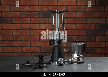 Set of different kitchen utensils on grey table Stock Photo