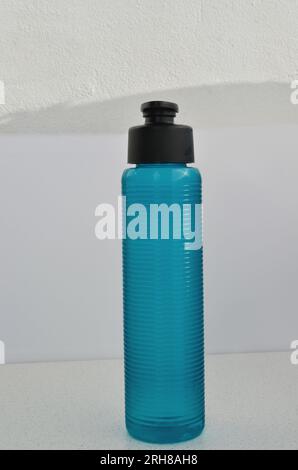 Blue water bottle close-up, ready to hydrate athletes during intense workouts. Health and wellness concept. Stock Photo