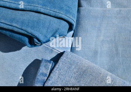 Detailed close-up of worn jeans, showing the stitching lines and the fabric's personality. Ideal for fashion and apparel projects. Stock Photo