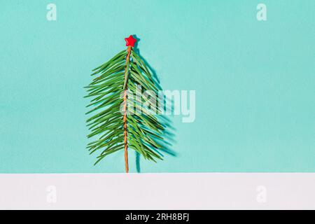 Small Christmas tree with red star on blue background Stock Photo