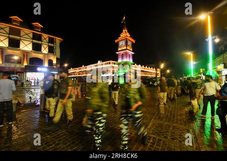 Srinagar, India. 14th Aug, 2023. People walk past the clock tower ...