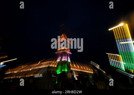 August 14, 2023, Srinagar, Jammu and Kashmir, India: People walk past the clock tower illuminated with India's national flag on the eve of country's Independence Day in Srinagar on August 14, 2023. (Credit Image: © Mubashir Hassan/Pacific Press via ZUMA Press Wire) EDITORIAL USAGE ONLY! Not for Commercial USAGE! Stock Photo